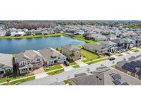 Beautiful aerial view of a lakeside community with well-maintained homes and lush green lawns at 2687 Chantilly Ave, Kissimmee, FL 34741