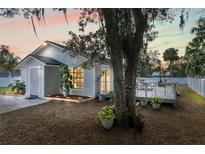 Charming one-story home featuring a well-maintained lawn, a cozy front porch, and a lovely wooden deck at 516 8Th St, Orlando, FL 32820