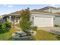 Charming single-story home with a well-maintained lawn and two-car garage, displaying great curb appeal at 2234 Bluebird Pl, St Cloud, FL 34771