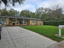 Charming single-story home with a well-maintained lawn and a cozy front porch at 261 N Third St, Winter Springs, FL 32708