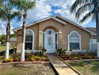 Charming single-story home with arched windows, well-maintained landscaping, and a welcoming walkway at 281 San Gabriel St, Winter Springs, FL 32708