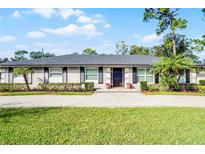 Charming single-story home featuring manicured landscaping, brick walkway, and lovely curb appeal at 322 Nelson Ave, Longwood, FL 32750