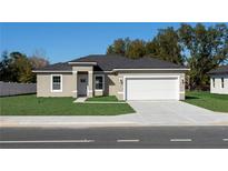 Charming single-story home with a well-manicured lawn and a two-car garage in a serene neighborhood at 325 Marion Oaks Trail, Ocala, FL 34473