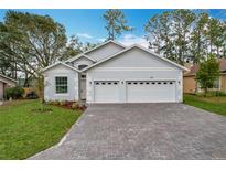Charming single-story home featuring a three-car garage and brick-paved driveway at 333 Bahia Cir, Longwood, FL 32750