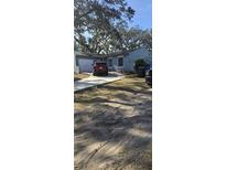 Charming single-story home with mature trees, attached garage and long driveway at 3404 Forestdale Dr, Orlando, FL 32808