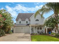 Charming two-story home with manicured lawn, two-car garage and mature trees adding curb appeal at 421 E Gore St, Orlando, FL 32806