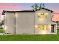 Two-story home with large windows providing ample natural light and a well-manicured lawn at 495 Dean Creek Ln, Orlando, FL 32825