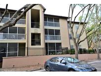 Exterior view of condo building with screened balconies and neatly manicured landscaping at 974 Leeward Pl # 205, Altamonte Springs, FL 32714