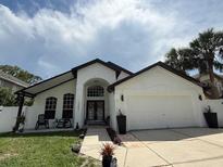 Well-maintained single-Gathering home featuring a 2-car garage and a beautifully landscaped front yard at 322 N Shadowbay Blvd, Longwood, FL 32779