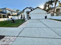 Beautiful one-story home featuring a well-manicured lawn and large driveway at 322 N Shadowbay Blvd, Longwood, FL 32779