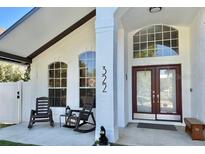 Welcoming front porch with seating and natural light, highlighting the home's entrance and curb appeal at 322 N Shadowbay Blvd, Longwood, FL 32779