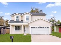 Charming two-story home with an attached two-car garage and neatly manicured lawn on a sunny day at 3778 Martin St, Orlando, FL 32806