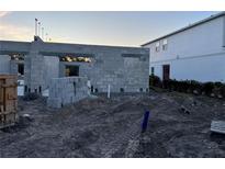 New construction shows the block foundation of a home, with dirt and blocks surrounding it at 4294 Campsite Loop, Orlando, FL 32824