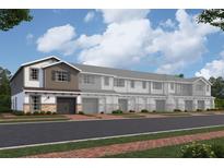 New townhomes featuring attached garages, stone accents, neutral colors, and professional landscaping at 4294 Campsite Loop, Orlando, FL 32824