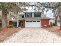 Charming two-story home featuring a red brick facade and a two-car garage at 4309 Enright Ct, Winter Park, FL 32792