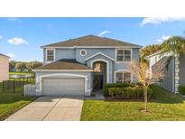 Charming two-story home featuring a well-manicured lawn and an attached two-car garage at 5361 Tortuga Dr, Orlando, FL 32837