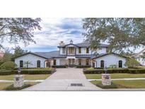 Gorgeous two-story home with meticulously manicured landscaping and a brick paver driveway at 5558 Brookline Dr, Orlando, FL 32819