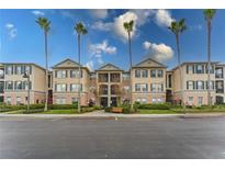 A charming condo building with well-maintained landscaping and beautiful palm trees at 8168 Boat Hook Loop # 707, Windermere, FL 34786