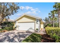 Charming home with a paved driveway, well-maintained landscaping, and a two-car garage at 11716 Astilbe Dr, Orlando, FL 32827