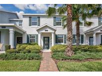 Charming townhouse exterior showcasing a beautifully landscaped front yard and inviting entrance at 11867 Pulitzer Pl, Orlando, FL 32832