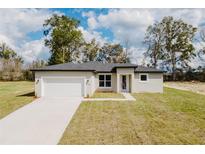 Charming single-story home with well-maintained lawn, attached garage, and neutral color scheme at 1633 Sw 168Th Loop, Ocala, FL 34473