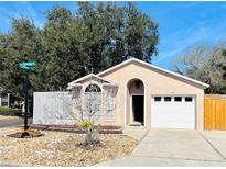 Charming single-story home with manicured landscaping, arched window, and attached one car garage at 459 Wood Rose Ln, Altamonte Springs, FL 32714