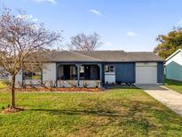 Charming single-story home with a well-maintained lawn and attached garage on a sunny day at 4804 Laddie Ct, Orlando, FL 32821