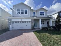 Charming two-story home featuring a two car garage and brick paver driveway at 5096 Shady Pines Dr, St Cloud, FL 34772