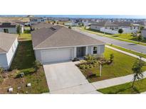 A charming single-story home with a well-manicured lawn, a two-car garage, and a concrete driveway at 545 Jerry Ln, Haines City, FL 33844