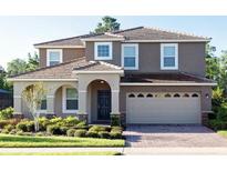 Beautiful two-story home featuring a well-manicured lawn, neutral paint, and a two car garage at 9114 Stromboli Ct, Kissimmee, FL 34747