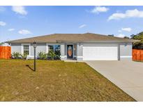 Charming single-story home featuring a well-maintained lawn and attached two-car garage at 13258 Sw 29Th Cir, Ocala, FL 34473