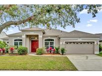 Charming single-story home with a well-maintained lawn and mature landscaping at 14851 Oldham Dr, Orlando, FL 32826