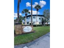 Beautiful Waterfall Cove condo complex with mature landscaping, blue skies, and palm trees at 1695 Lee Rd # B109, Winter Park, FL 32789