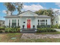 Charming single-story home with a bright red front door and well-manicured landscaping at 2006 N Westmoreland Dr, Orlando, FL 32804