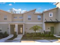 Modern townhome exterior featuring a contemporary design, manicured landscaping, and inviting entrances at 2377 Reading Trl, Kissimmee, FL 34746