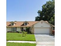 Charming single-Gathering home with a lush green lawn and a two-car garage at 8851 Hillsdale Dr, Orlando, FL 32818