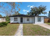 Charming single-story home with a well-manicured front yard and a gray concrete walkway leading to the front door at 913 Lake Ave, Edgewater, FL 32132