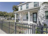 Charming home with a covered front porch, black railing, and a well-maintained walkway leading to the entrance at 1401 E Michigan St, Orlando, FL 32806