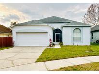 Charming single-story home featuring a two-car garage, well-maintained lawn and beautiful architectural detail at 2049 Crosscreek Ct, Oviedo, FL 32766
