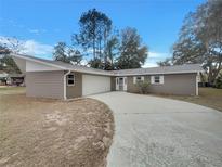 Charming single-story home featuring a long driveway and attached two-car garage at 38 Emerald Ct, Ocala, FL 34472