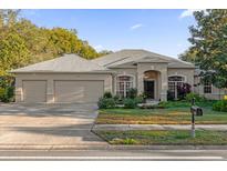 Charming single-story home with a well-manicured lawn and a three-car garage at 908 Saza Run, Casselberry, FL 32707