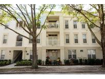 Charming condo building with multiple balconies and manicured landscaping at 1020 Siena Park W Blvd # 103, Celebration, FL 34747