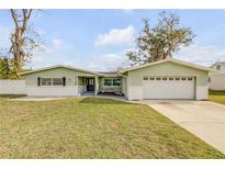 Charming single-story home with a well-manicured lawn and attached two-car garage at 2130 Pope Ave, South Daytona, FL 32119
