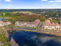 Scenic aerial view of condos overlooking a pond and lush green landscape at 706 Westpark Way # 203, Celebration, FL 34747