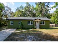 Charming single-story home with a well-maintained front yard, inviting entrance, and a long concrete driveway at 9 Lake Dr, Debary, FL 32713