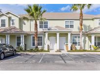 Inviting townhouse featuring a lushly landscaped front yard and convenient parking at 17403 Placidity Ave, Clermont, FL 34714