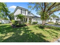 Charming two-story home with a manicured lawn, mature trees, and a well-maintained exterior at 1744 Setting Sun Loop, Casselberry, FL 32707