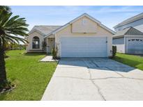 Charming single-story home featuring a two-car garage and well-maintained lawn at 210 Sonoma Valley Cir, Orlando, FL 32835