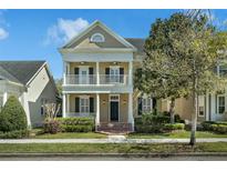 Charming two-story home with a welcoming porch and manicured landscaping at 2875 Stanfield Ave, Orlando, FL 32814