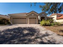 Charming single-story home featuring a three-car garage and a beautifully paved driveway at 3901 Bowfin Trail, Kissimmee, FL 34746
